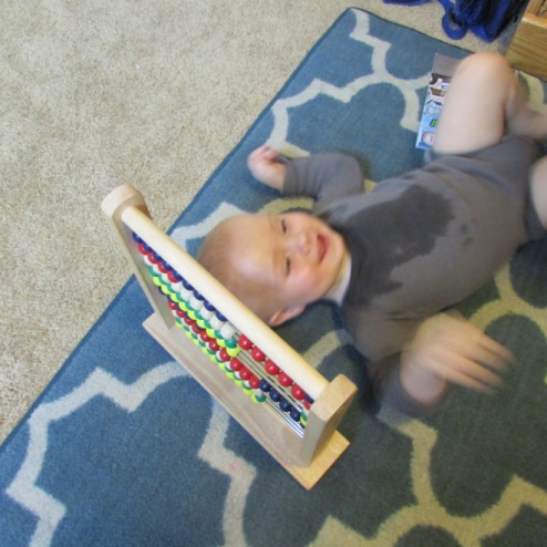 baby plays abacus
